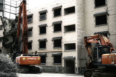 Construction site by buildings in city