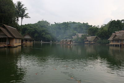 Calm lake with houses in background