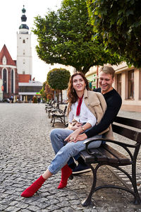 Portrait of smiling young woman sitting outdoors