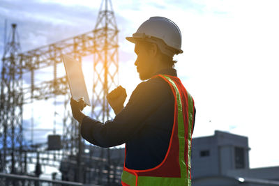 Side view of man working at construction site