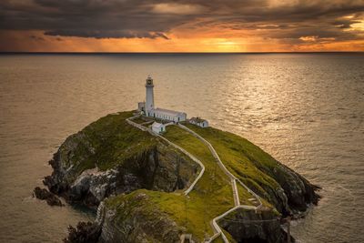 Scenic view of lighthouse on rock