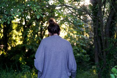 Rear view of woman in forest