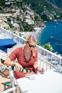 Woman sitting on boat against the sea