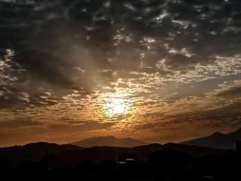 Scenic view of silhouette mountains against sky during sunset