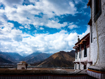 Low angle view of building against cloudy sky