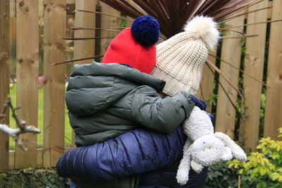 Rear view of grandma and grandson outside  in garden