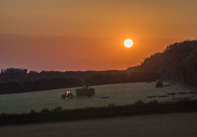 Scenic view of field against sky during sunset