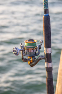 The crank of a fishing rod with reel foot, reel seat, spool, coiled line and spool brake