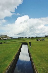 Scenic view of landscape against cloudy sky