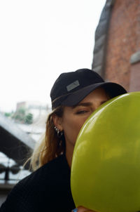 Portrait of woman wearing hat against sky