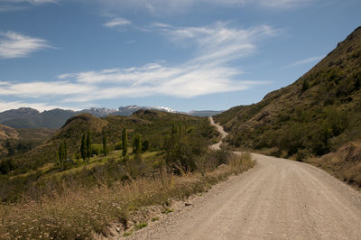 Road amidst mountains against sky