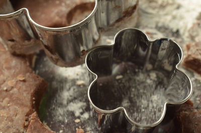 Close-up of flower shape pastry cutters on chocolate dough