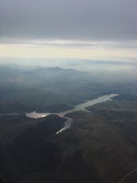 Aerial view of landscape against cloudy sky