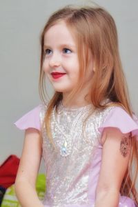 Close-up portrait of smiling girl at home