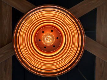 Close-up of illuminated light bulb on table