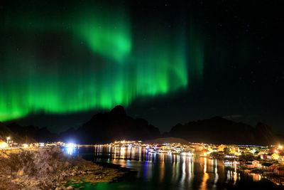 Scenic view of illuminated mountains against sky at night