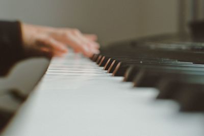 Close-up of person playing piano