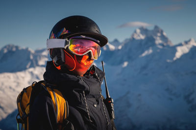 Skier smiling happy cheerful satisfied woman in warm windbreaker jacket ski goggles mask glasses