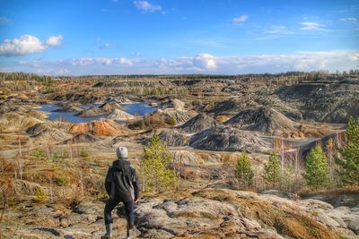 Rear view of man standing on rock