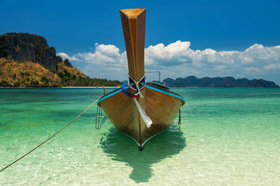 Long tail boat on water at thale waek beach in krabi, thailand. typical image of thailand vacation.