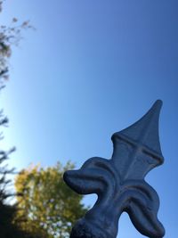 Low angle view of statue against clear blue sky