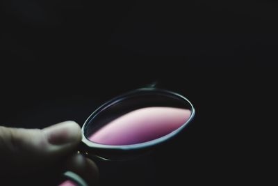 Close-up of woman hand holding black background