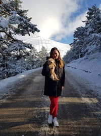 Full length of woman standing on snow against sky