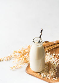 Close-up of drink on table against white background