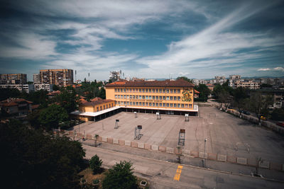 A stunning aerial view of a city school, nestled among the glittering towers of the urban landscape