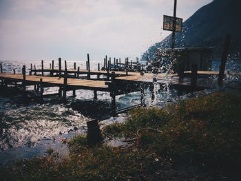 Jetty over lake against sky