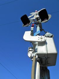 Low angle view of lamp post against clear blue sky