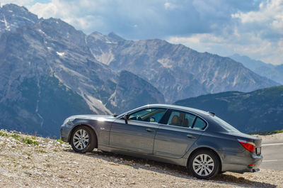 Vintage car on mountain range against sky