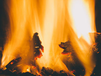 Close-up of bonfire against orange sky