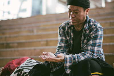 Beggar sitting on steps