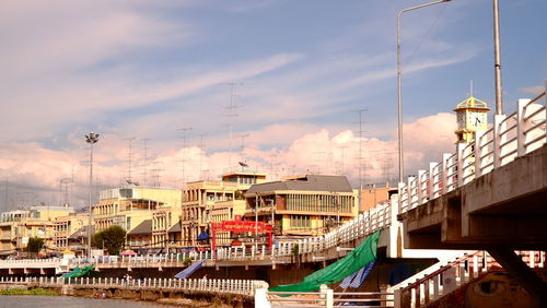 Buildings in city against cloudy sky