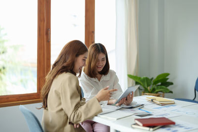 Businesswomen using digital tablet in office