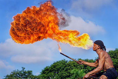 Rear view of man standing against sky