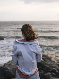 Rear view of woman looking at sea