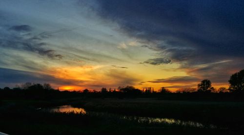 Scenic view of field against sky during sunset