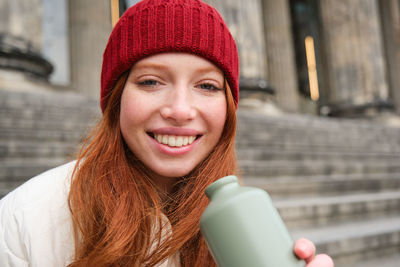 Portrait of young woman drinking coffee