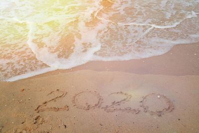 High angle view of text on beach