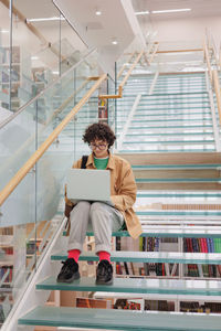 Low angle view of woman standing in office