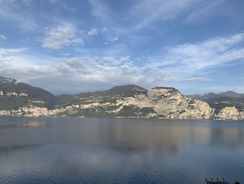 Scenic view of lake by mountains against sky