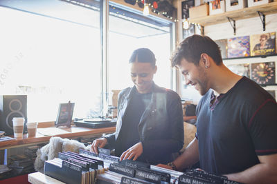 Young man and woman in a record store.