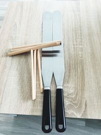 High angle view of kitchen utensils on wooden table
