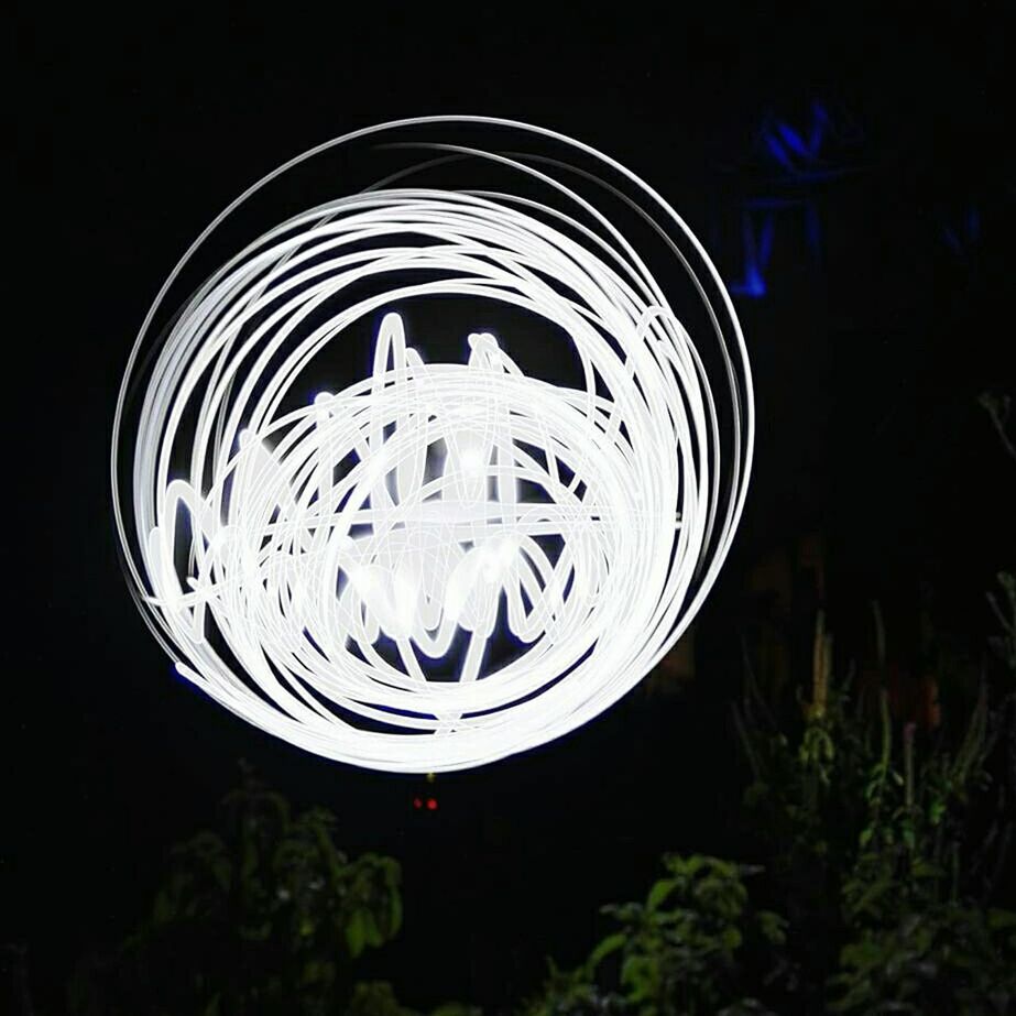 circle, night, illuminated, reflection, low angle view, close-up, glass - material, black background, no people, studio shot, transparent, lighting equipment, geometric shape, pattern, glowing, water, long exposure, round, motion, dark