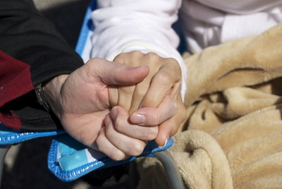 Cropped image of person with holding hands