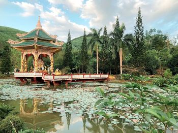 Gazebo by lake against sky