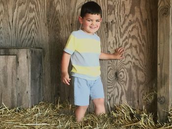 Portrait of happy boy standing in grass