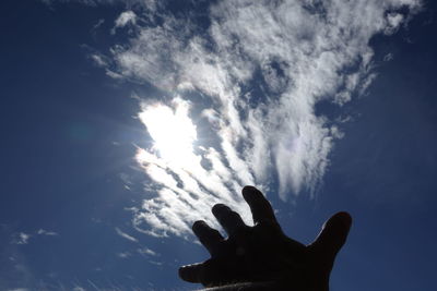 Low angle view of silhouette man against sky